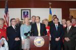 Leg. Rob Calarco at the podium discusses passage of his bill, IR 2025, requiring county roadways to be designed to accommodate all users. (left to right) Legislators Wayne Horsley and Kara Hahn (a co-sponsor of the bill); Leg. Calarco, Will Stoner of the AARP; Leg. Ricardo Montano. (Rear left to right) Eric Alexander of Vision Long Island; Sal Russo, 2nd vice president of SCAME; and Leg. William (Doc) Spencer. 